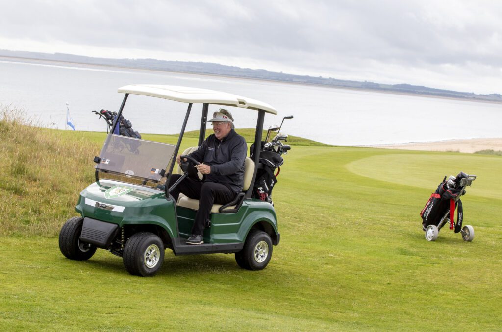 A golfer at Royal Dornoch riding a STAR EV Capella 2 Pro.